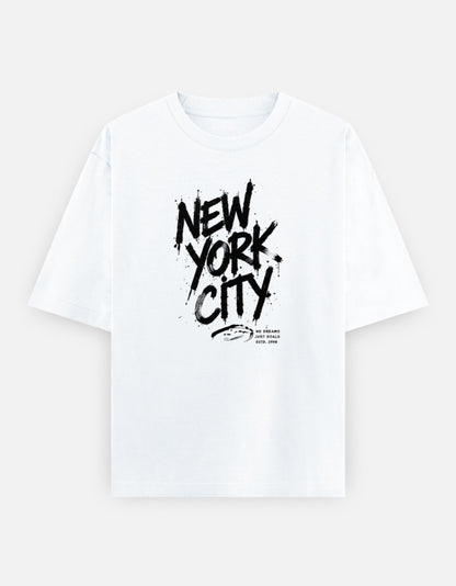 White oversized t-shirt featuring a bold black graffiti-style "New York City" typography graphic printed on the front.