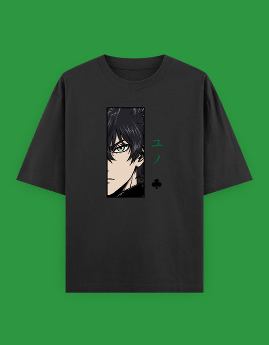 Black oversized t-shirt featuring a minimalist anime-inspired portrait with emerald green Japanese typography and subtle graphic elements printed on the front.